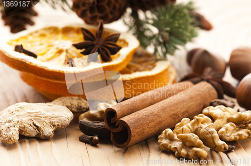 Image of Different kinds of spices, nuts and dried oranges - christmas de