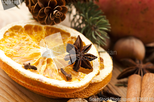 Image of Different kinds of spices, nuts and dried oranges - christmas de