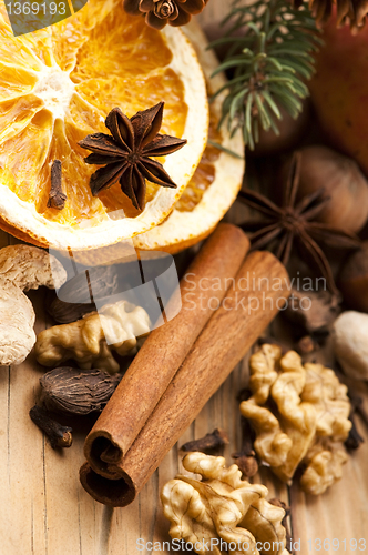 Image of Different kinds of spices, nuts and dried oranges - christmas de