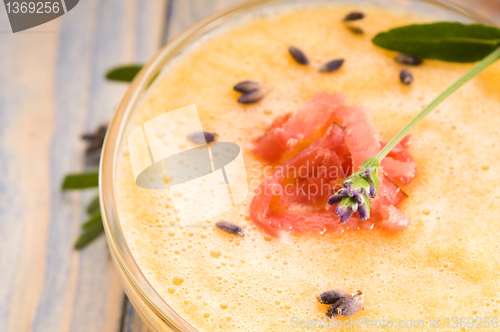 Image of fresh melon soup with parma ham and lavender flower