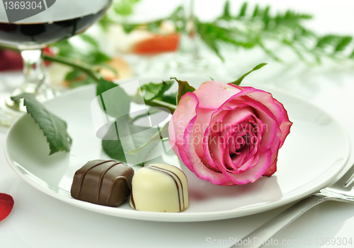 Image of romantic dinner with rose on a plate