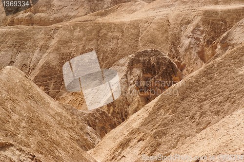 Image of Textured orange hills in the desert 