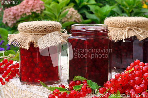 Image of Jars of homemade red currant jam with fresh fruits