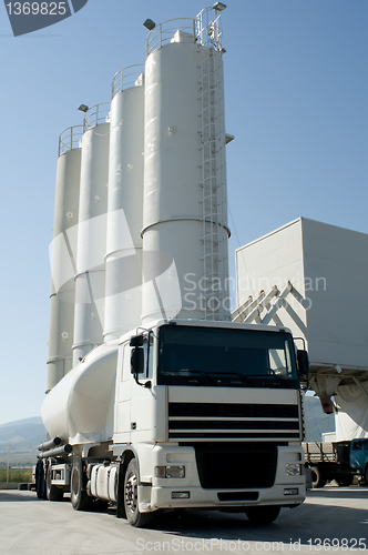 Image of Cement factory with silos and mixer truck