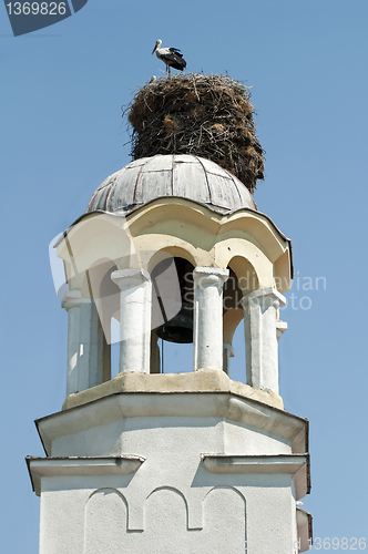 Image of Stork in nest on dome of a church
