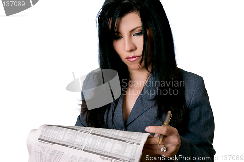 Image of Business woman holding a newspaper and pen