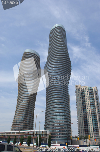 Image of Tow round high rise buildings.