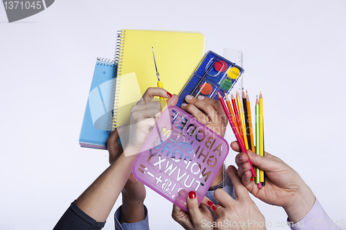 Image of Hands holding education objects