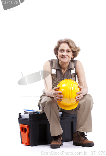 Image of Senior woman sitting in a toolbox