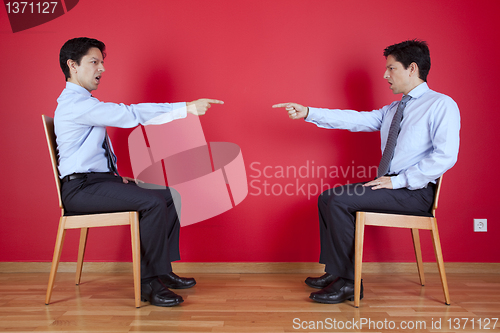 Image of Twin businessman fighting