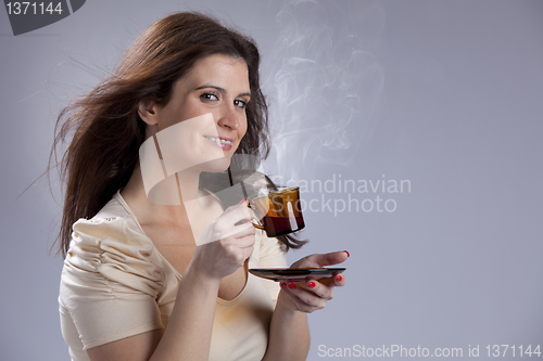 Image of Woman drinking a hot drink