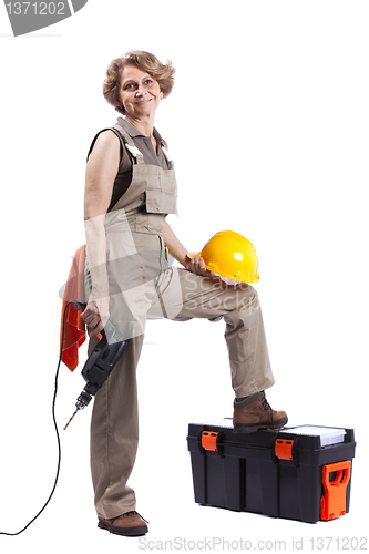 Image of Senior woman with a drill tool