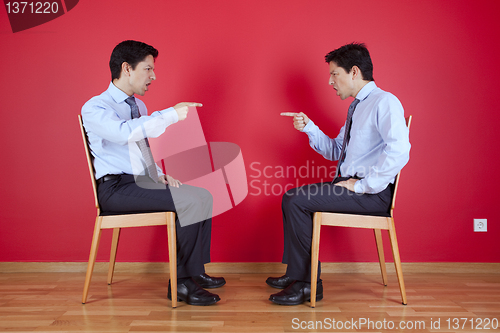 Image of Twin businessman fighting