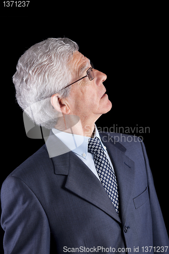 Image of Senior businessman looking up