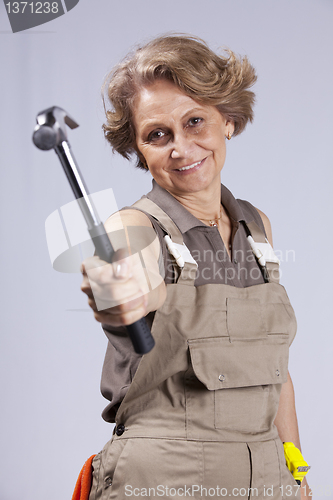 Image of Senior woman with a hammer