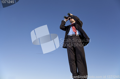 Image of Businessman searching with his binoculars