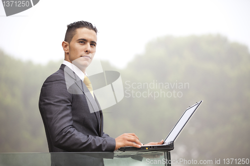 Image of Modern businessman at the office balcony