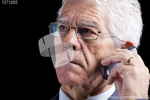 Image of Senior Businessman talking at the cellphone