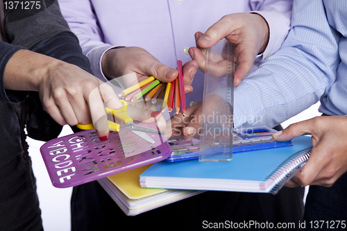 Image of Hands holding education objects