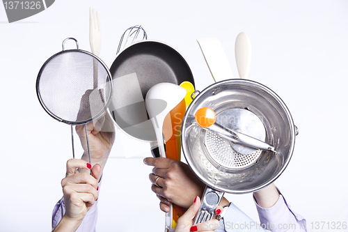 Image of Hands holding kitchenware tools