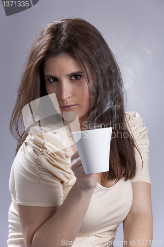 Image of Woman drinking a hot drink