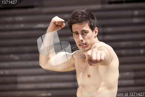 Image of Athlete showing his muscles