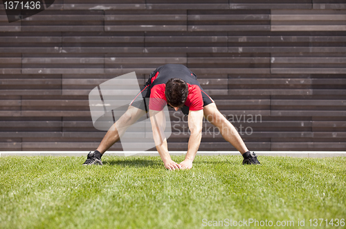Image of Athlete warming and stretching