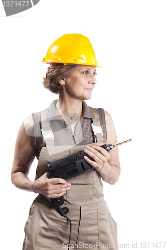 Image of Senior woman with a drill tool