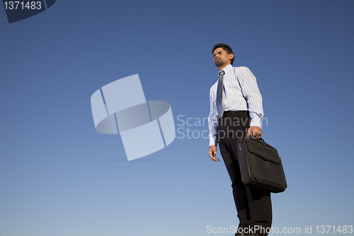 Image of Powerful businessman holding a briefcase