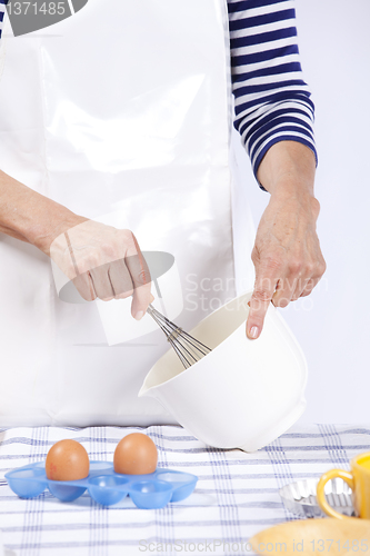 Image of Hands mixing eggs