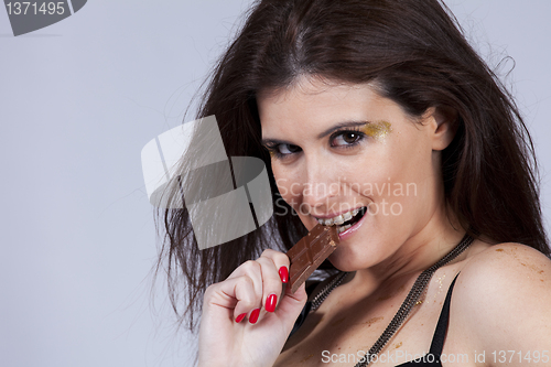 Image of Woman biting chocolate