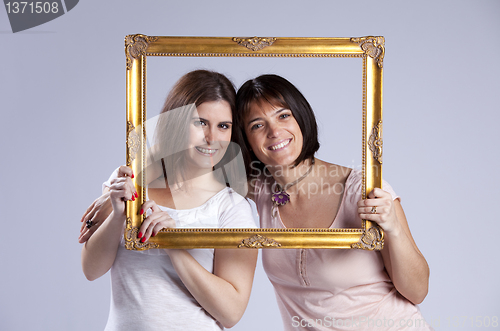 Image of two woman inside a picture frame