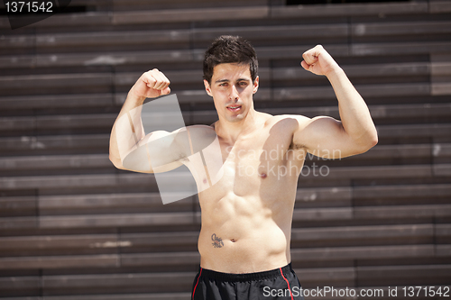 Image of Athlete showing his muscles
