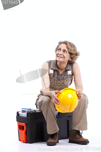 Image of Senior woman sitting in a toolbox
