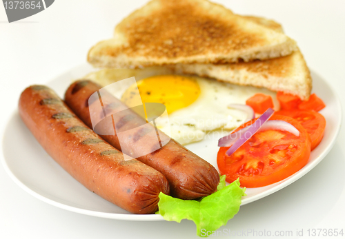 Image of grilled polish sausages with egg and vegetables 