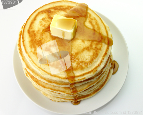 Image of pancakes with butter and maple syrup.