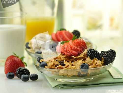 Image of cereal with fruits ,milk and juice 