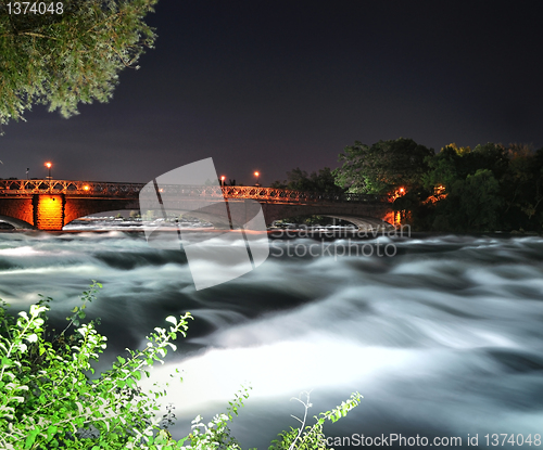 Image of mountain river with bridge at the night time
