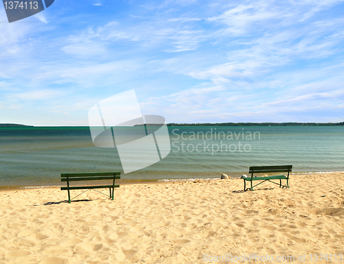 Image of empty beach with benches 