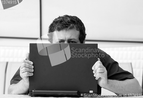 Image of Man's eyes over laptop