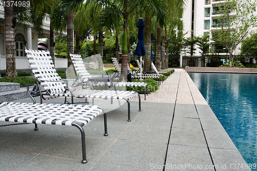 Image of Swimming pool with chairs