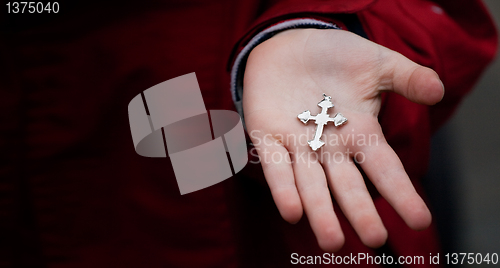 Image of Cross in child hands 