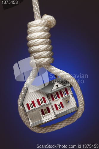 Image of House Tied Up and Hanging in Hangman's Noose on Blue