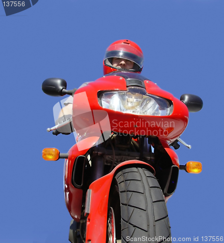 Image of Man on a red bike