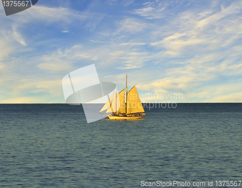 Image of Single sail boat on the lake. 