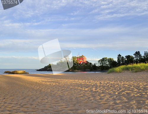 Image of lighthouse on a lake at sunset
