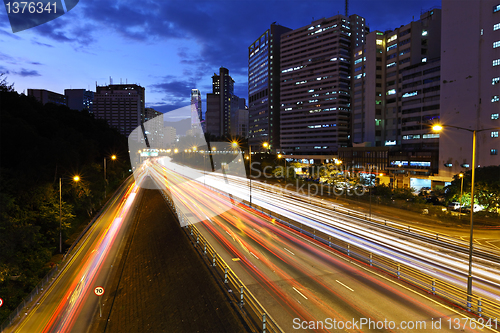 Image of light trails on modern city at night