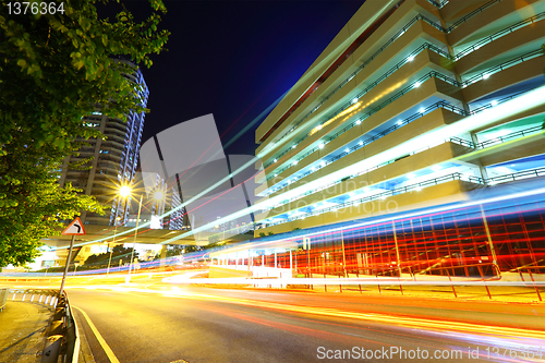 Image of light trails on modern city at night