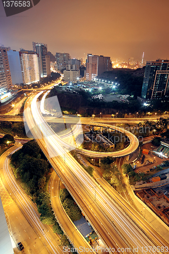 Image of Freeway in night with cars light in modern city. 