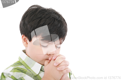 Image of A boys prays earnestly to his creator in heaven 